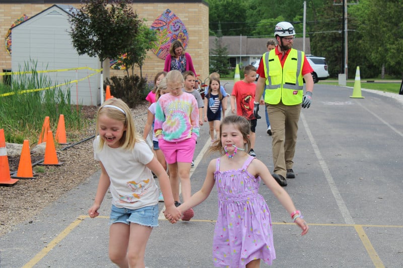 Photo of students walking outside of school