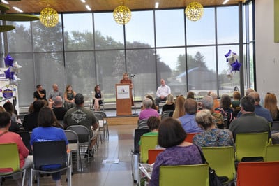 person speaking at a podium on a stage